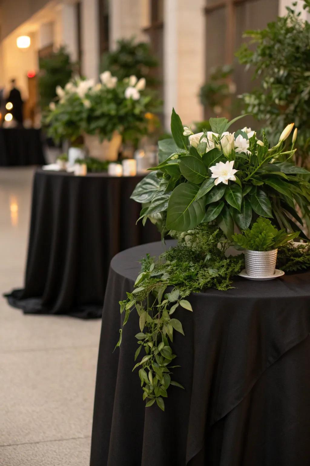 Bring the elegance of a garden indoors with lush greenery on a black tablecloth.