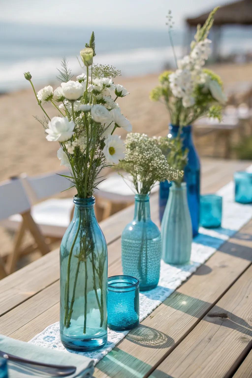 Blue glass vases bring a splash of ocean color to your centerpiece, adding elegance and simplicity.
